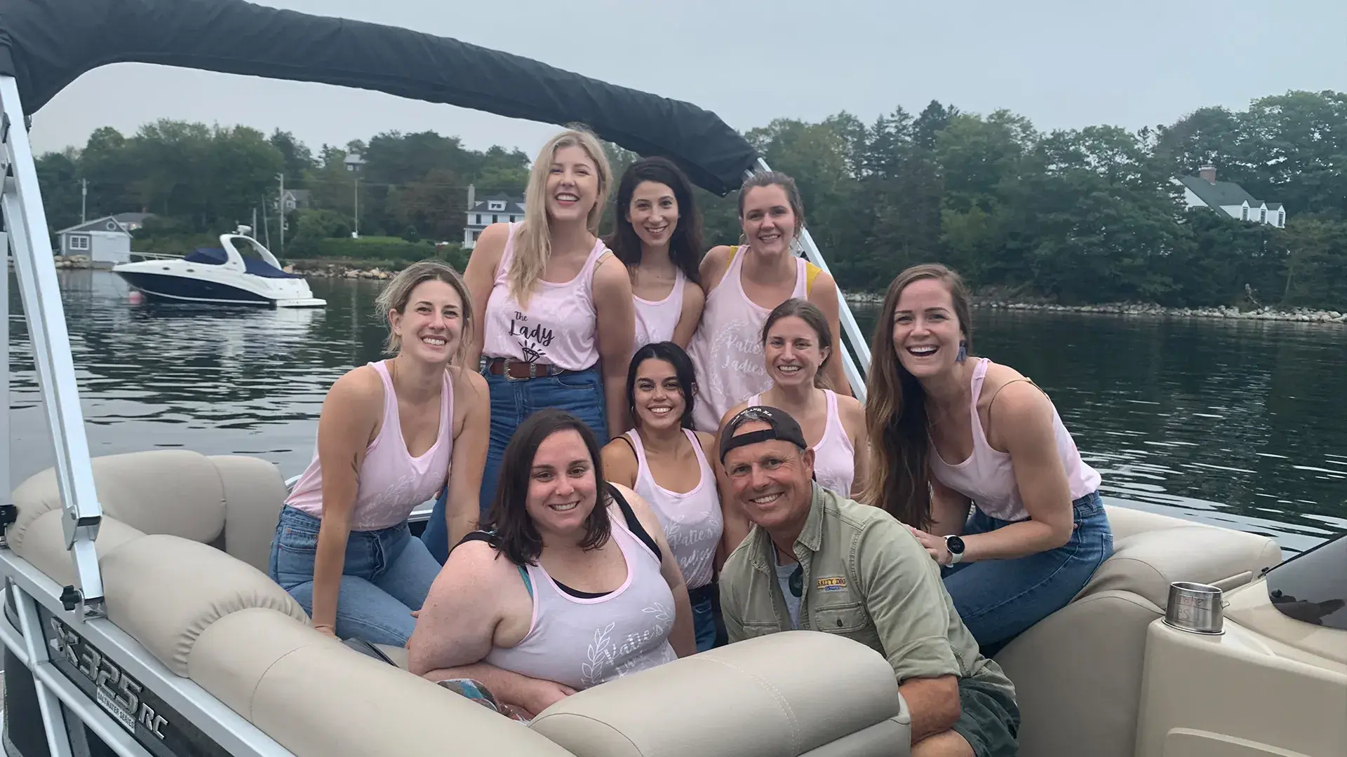 Friends celebrating on a private boat charter on Mahone Bay